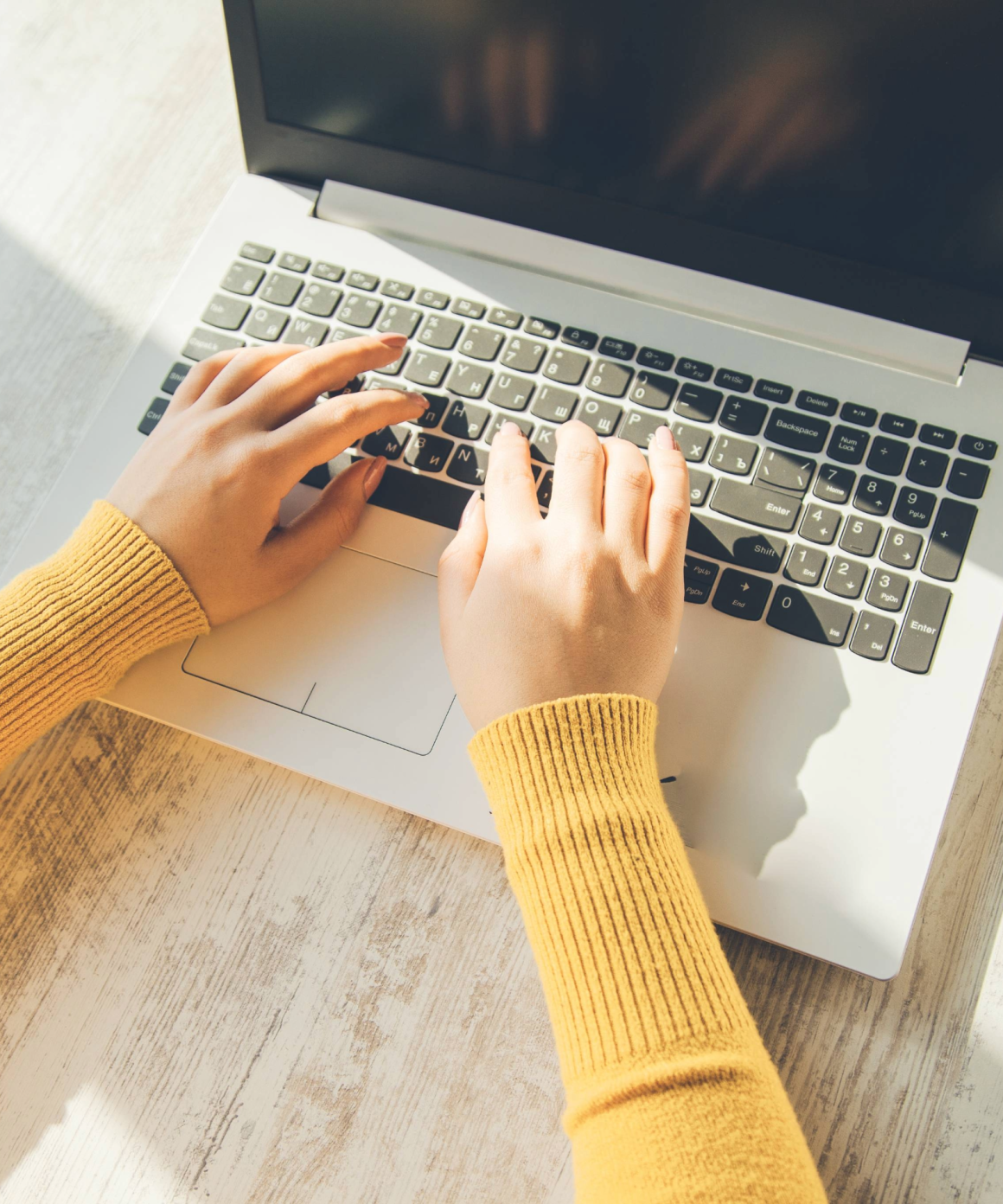 Woman typing on a Windows laptop
